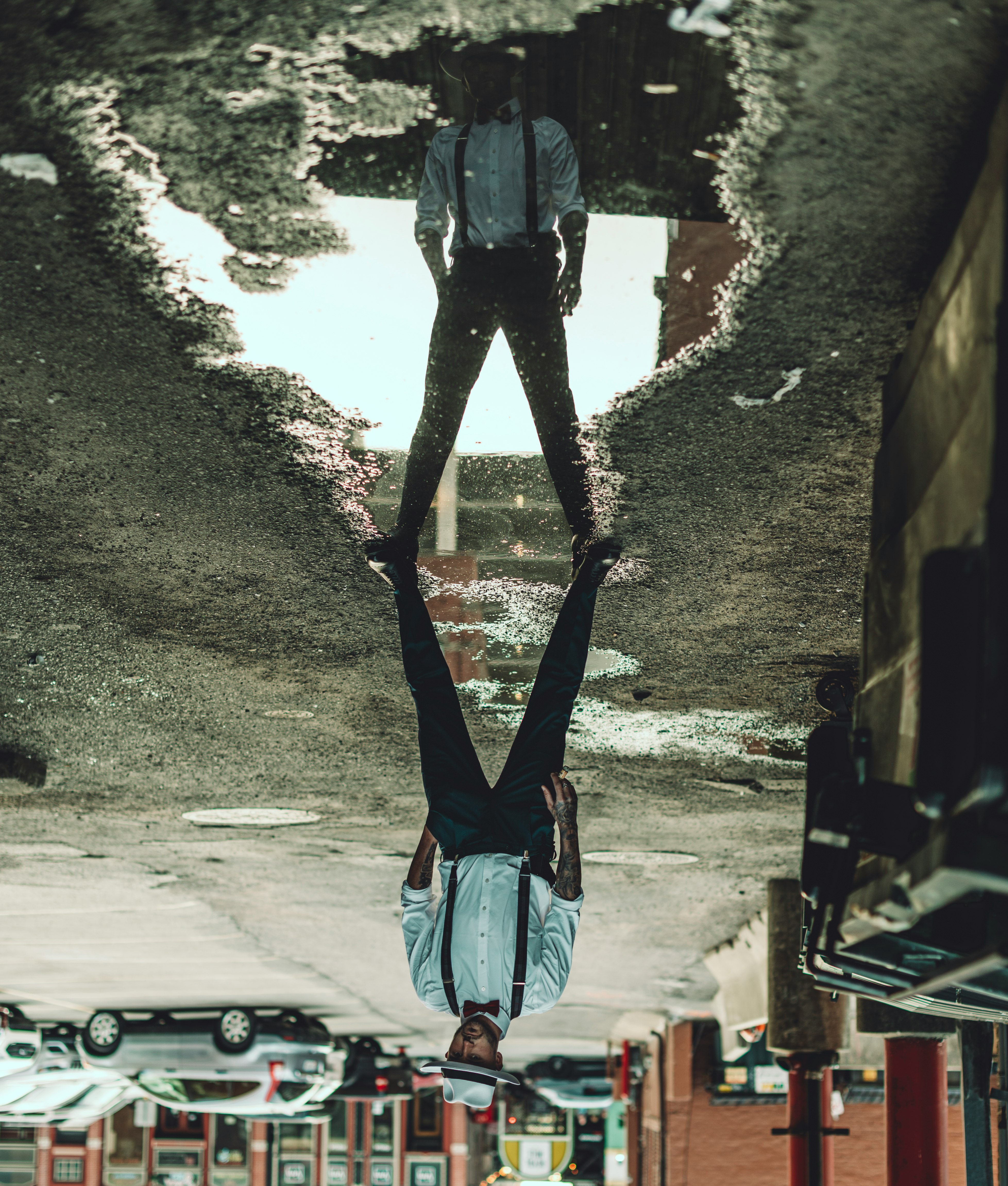 man in blue denim jacket and blue denim jeans standing on brown rock